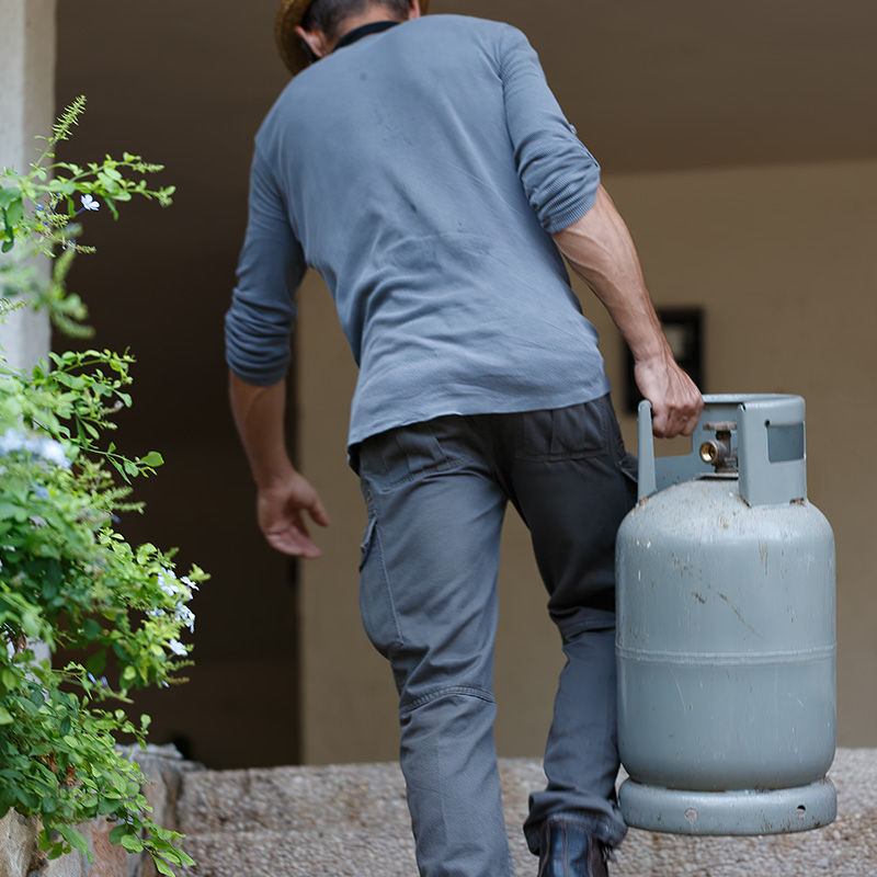 A man carrying a gas cylinder