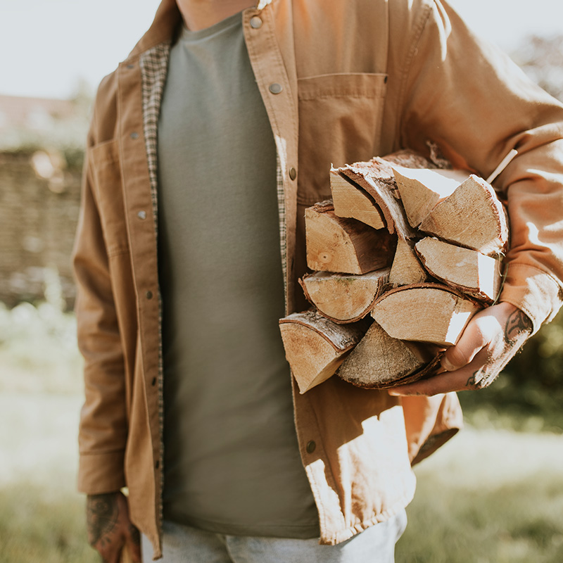 A man carrying wood chips